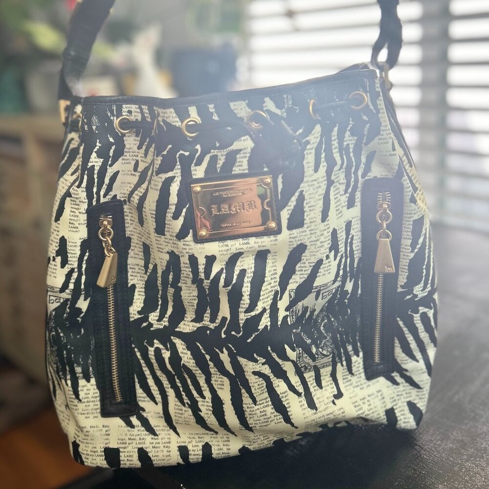 L.A.M.B. by Gwen Stefani Mandalay Newsprint Zebra Drawstring Leather Bucket Hobo